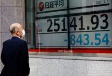 Asian stocks lose bounce from shorter China quarantine, slip on inflation fears