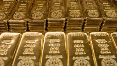 Gold prices rise as dollar sinks on bets of less hawkish Fed