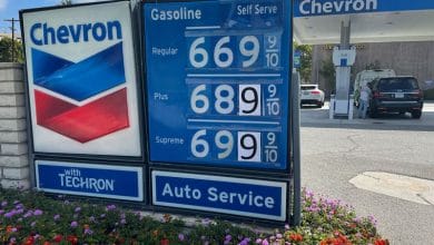 Exxon, Chevron split over how to manage rising cash piles